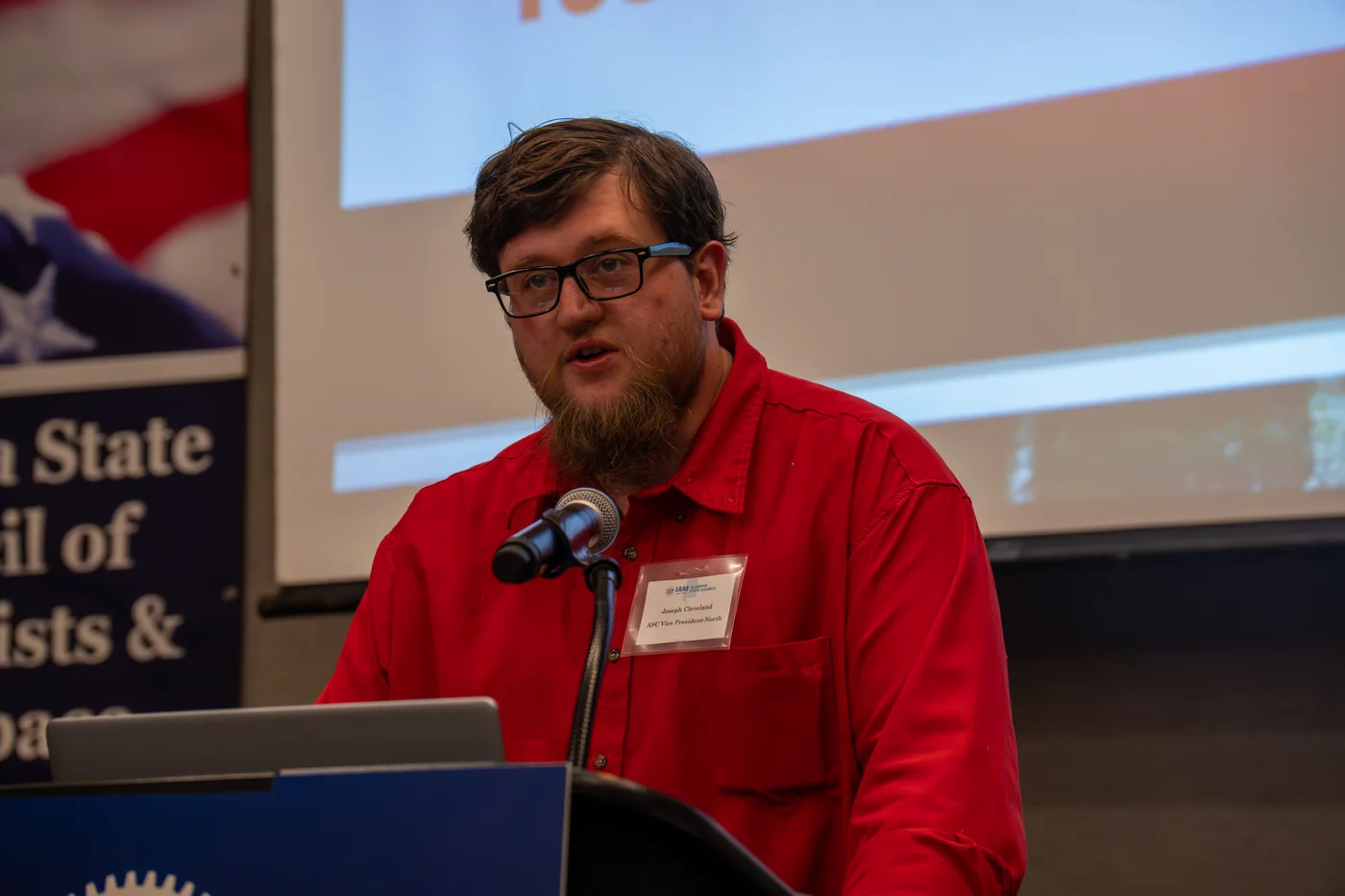 Joseph Cleveland speaking at a microphone during an IAM union event.